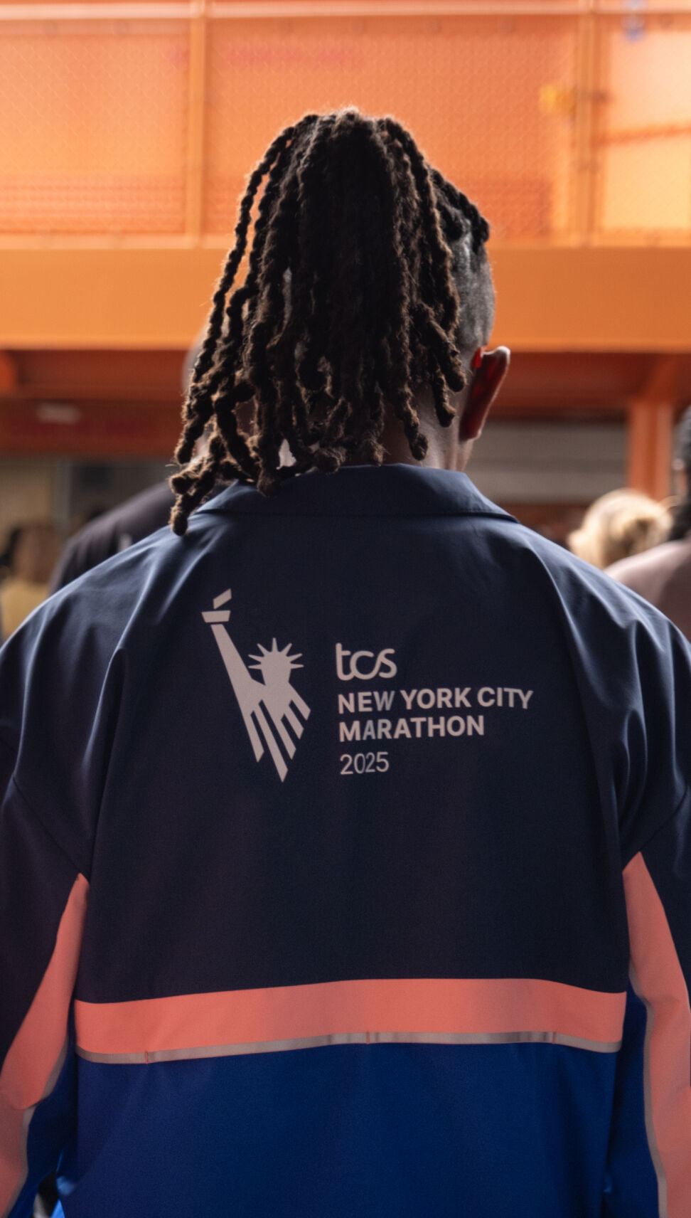 Two men wearing New York City Marathon apparel 